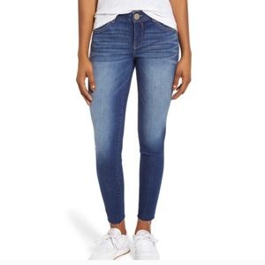 Dark wash. Raw hem skinny jean